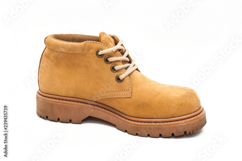 Yellow boot on a tractor sole. White isolated background