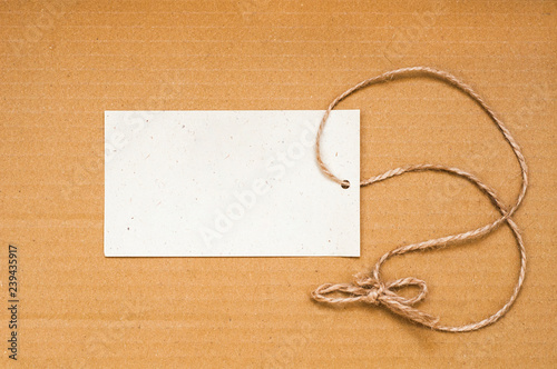 Paper label with rope on brown background. Empty
