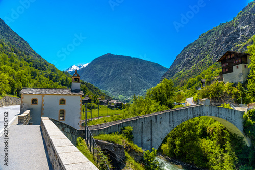 Ancient stone bridge over the moutnain river in Swiss Alps, Stalden, Visp, Wallis, Valais, Switzerland photo