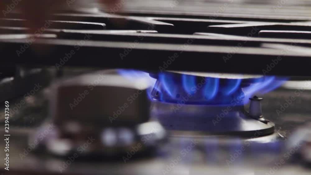 Close up of hand turning on, then turning off gas stove, with blue flame Stock ビデオ Adobe Stock