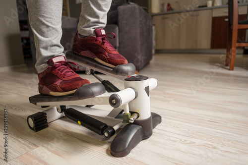 feet of a young woman on stepper, sport at home