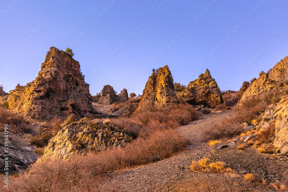 Jagged and rocky mounds on the side of a mountain