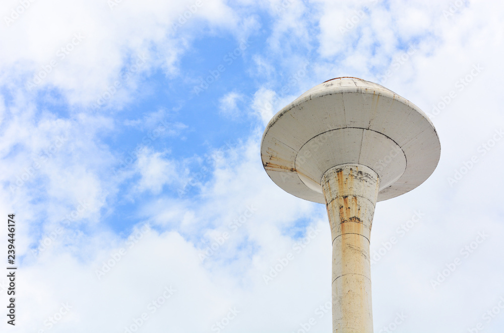 old white water tank tower with clouds and blue sky background, clipping path