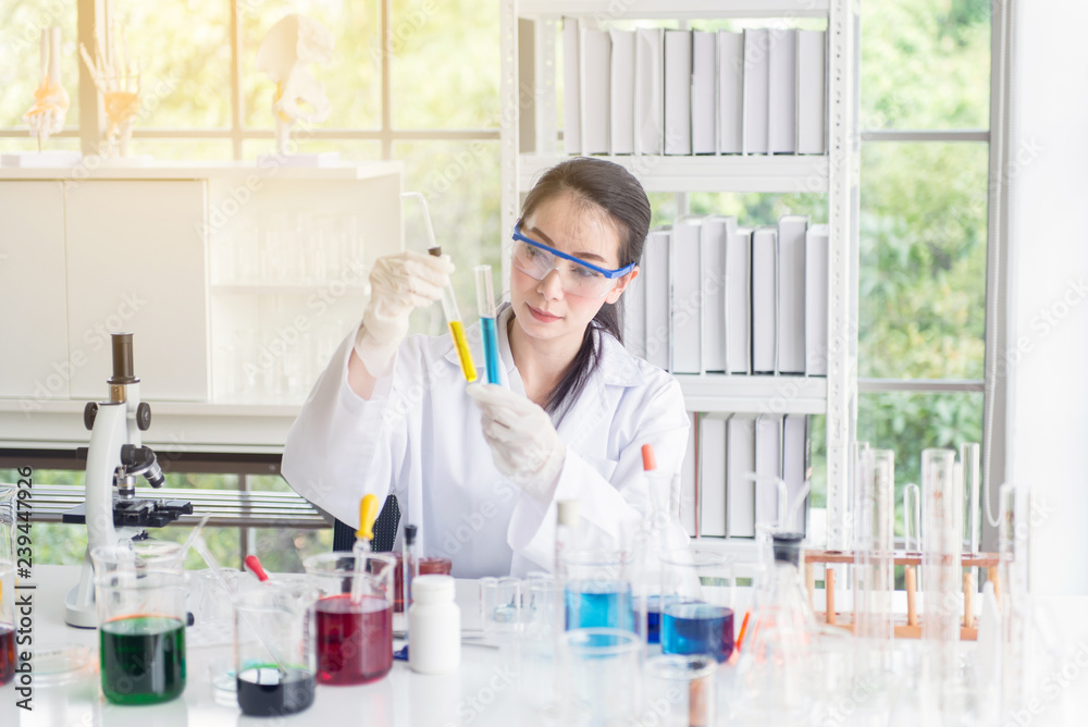 Scientist female working putting medical chemicals sample in test tube at laboratory Scientist female working putting medical chemicals sample in test tube at laboratory
