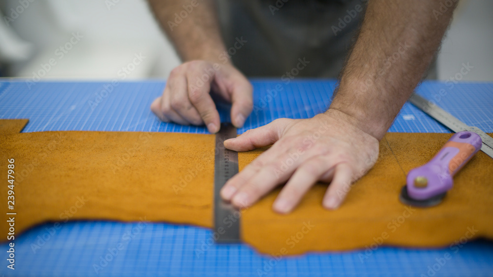 Hands of the master. Marking leather for making bags, purses or shoes. Hands of the master. Marking leather for making bags, purses or shoes.