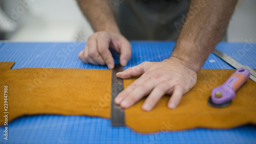 Hands of the master. Marking leather for making bags, purses or shoes.