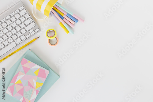 keyboard with coloured pens in white background
