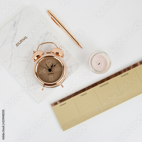 clock and book on white table