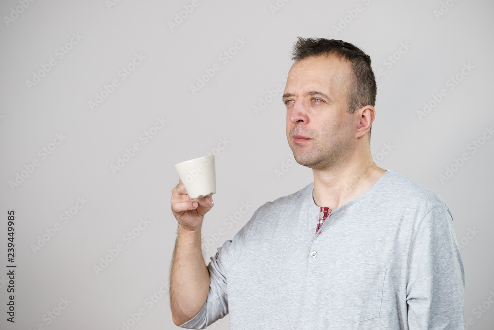 Tired man enjoying his coffee Tired man enjoying his coffee