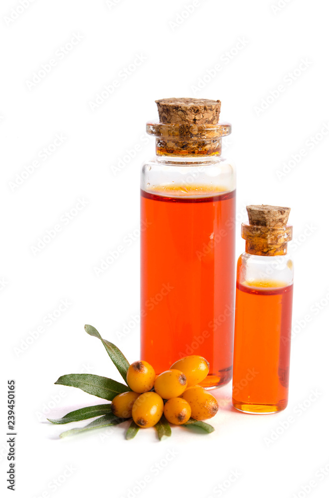 Sea buckthorn and two bottles with sea buckthorn oil isolated on white background Sea buckthorn and two bottles with sea buckthorn oil isolated on white background