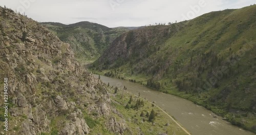 Beartrap Canyon trail green rocky mountains next to Madison river valley in Bozeman Montana countryside
(drone shot) photo