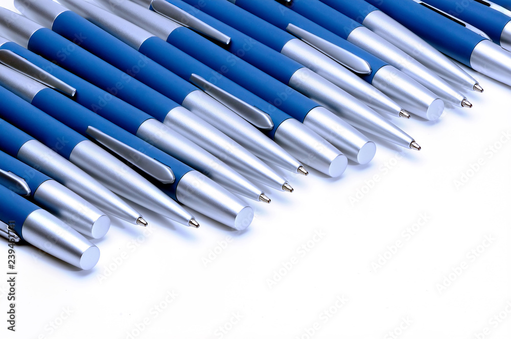 Silver-blue metal pens isolated on white background. Silver-blue metal pens isolated on white background.