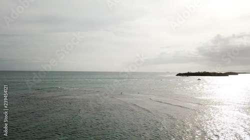 AERIAL: seen from the height of the waves of the sea and the tide in the vicinity of an island photo