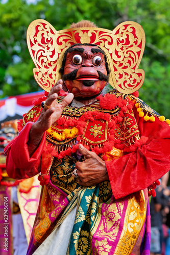 Dancer man in traditional Balinese costume, face mask Tari Wayang Topeng - character of Bali culture. Temple ritual dance at ceremony on religious holiday. Ethnic festivals, arts of Indonesian people