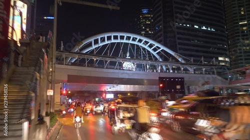 Traffic at Chong Nonsi, Scooter driving in busy traffic in Bangkok, Thailand photo