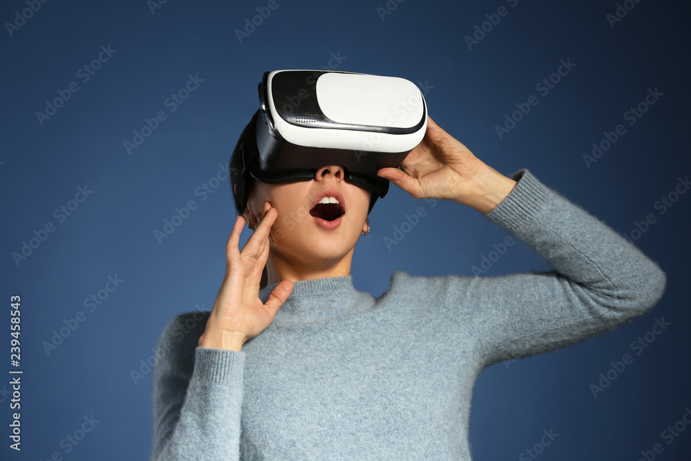 Young woman with virtual reality glasses on color background Young woman with virtual reality glasses on color background