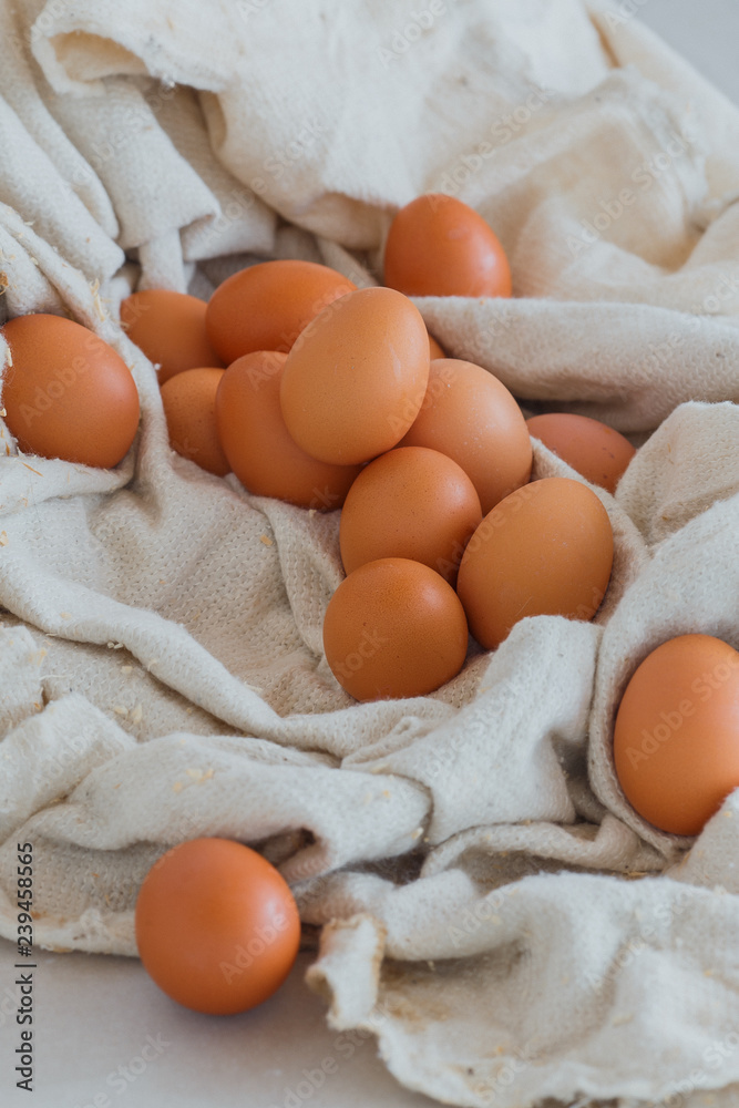 a lot of yellow eggs in the fabric, preparation for Easter, fresh chicken a lot of yellow eggs in the fabric, preparation for Easter, fresh chicken
