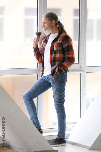 Senior man drinking wine ne...