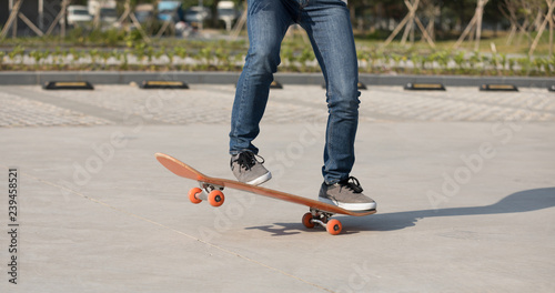 Skateboarder skateboarding on parking lot