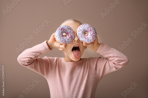 Cute little girl with donut...