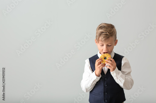 Cute little boy with donut ...