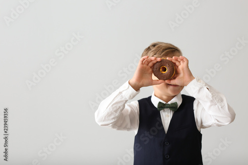 Cute little boy with donut ...