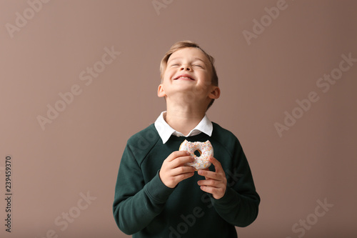 Cute little boy with donut ...
