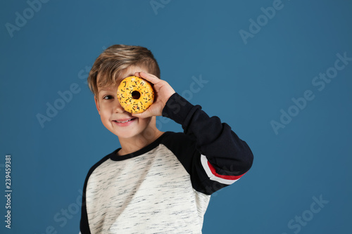 Cute little boy with donut ...