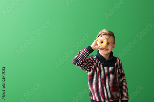 Cute little boy with donut ...