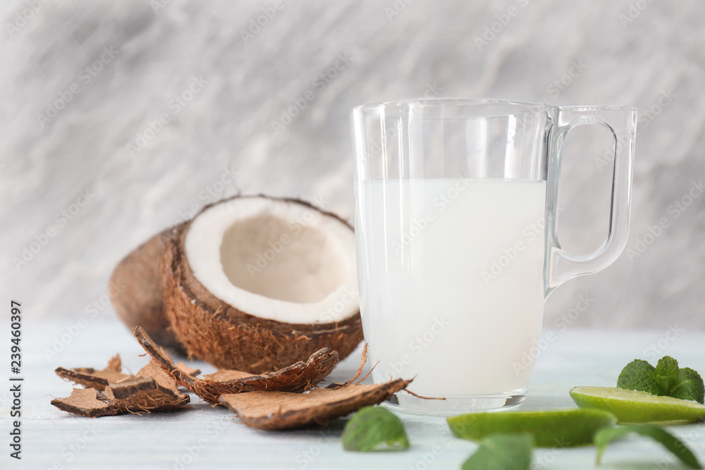 Glass cup of tasty coconut water on table Glass cup of tasty coconut water on table