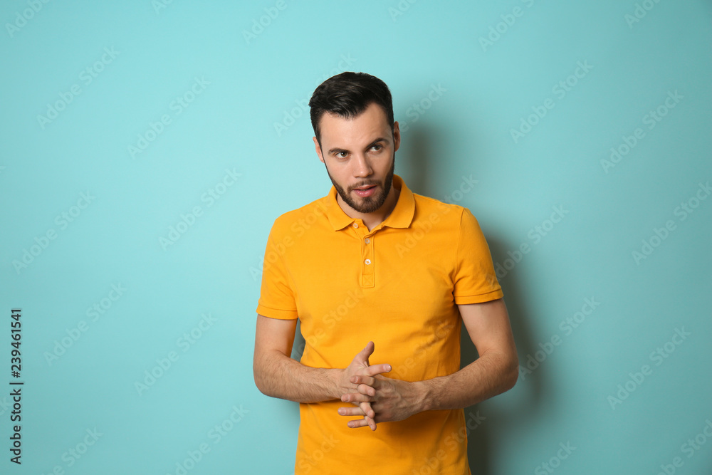 Fashionable young man on color background