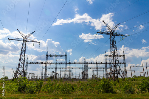 High voltage power lines in the winter. High-voltage transformer substation.