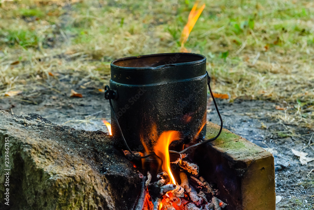 Cooking food in a kettle on bonfire Cooking food in a kettle on bonfire