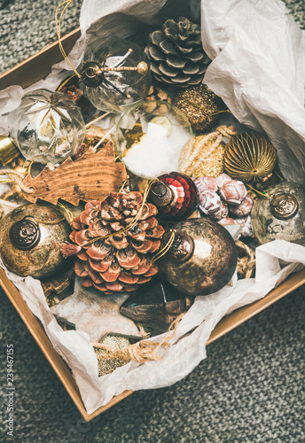 Christmas tree decoration toys and pine cones in wooden box