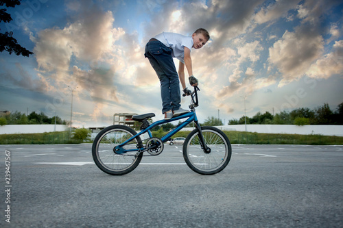 Close view of young biker doing reckless tricks on bike