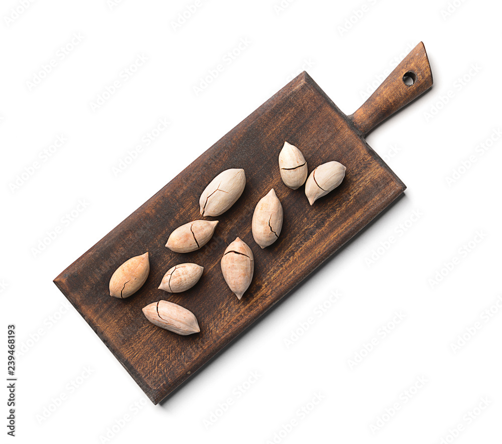 Wooden board with pecan nuts on white background Wooden board with pecan nuts on white background