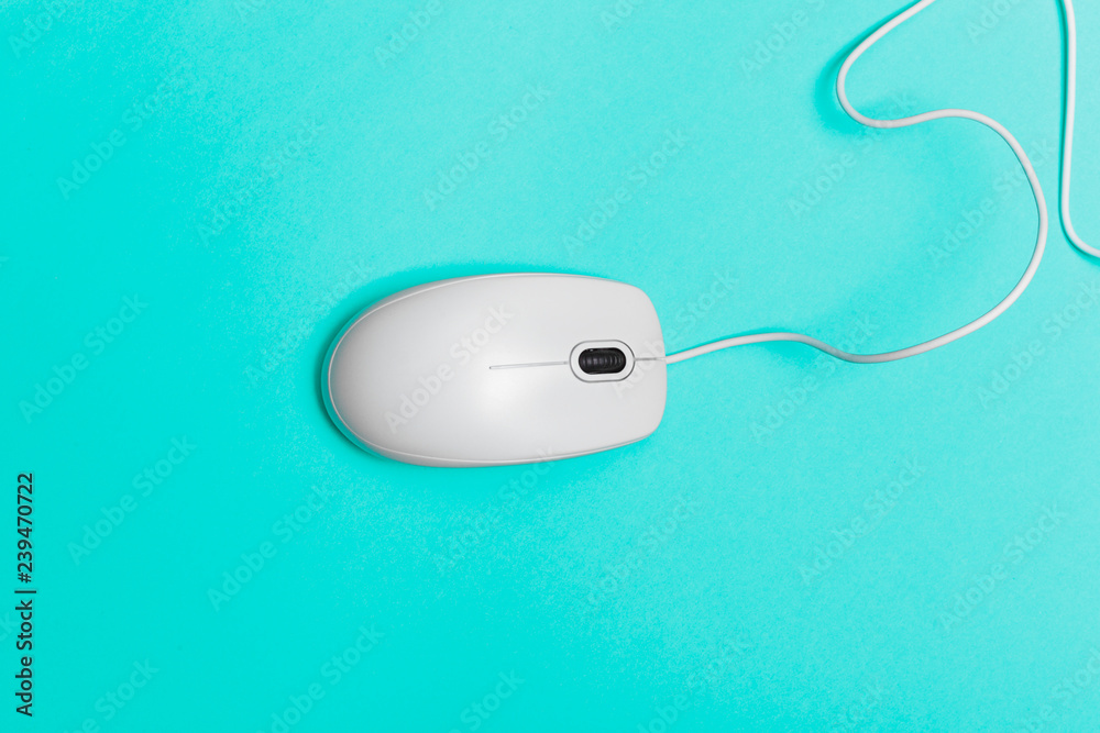 Computer mouse on a turquoise paper background Computer mouse on a turquoise paper background