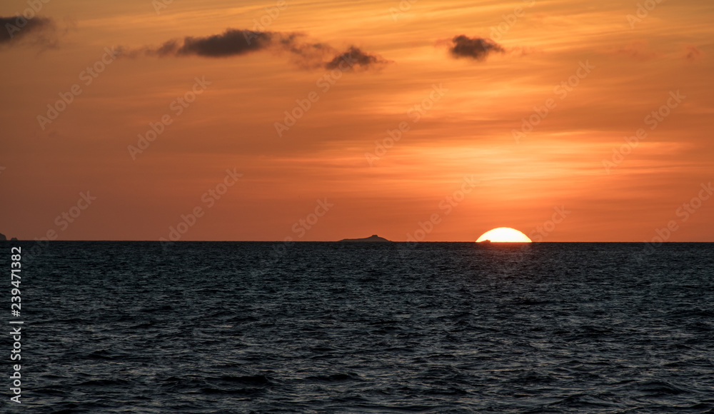 Orange sunset on the ocean at the Galapagos Islands Orange sunset on the ocean at the Galapagos Islands