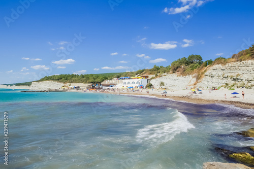 People resting on beach of resort the Black Sea Coast of Divnomorskoe town. Krasnodar region, Russia