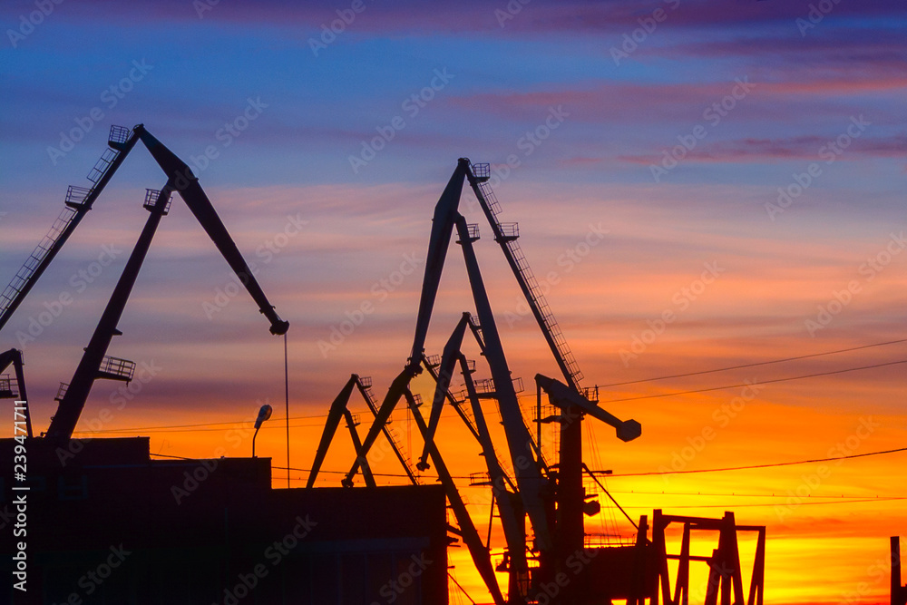 port cranes on the background of sunset. soft focus