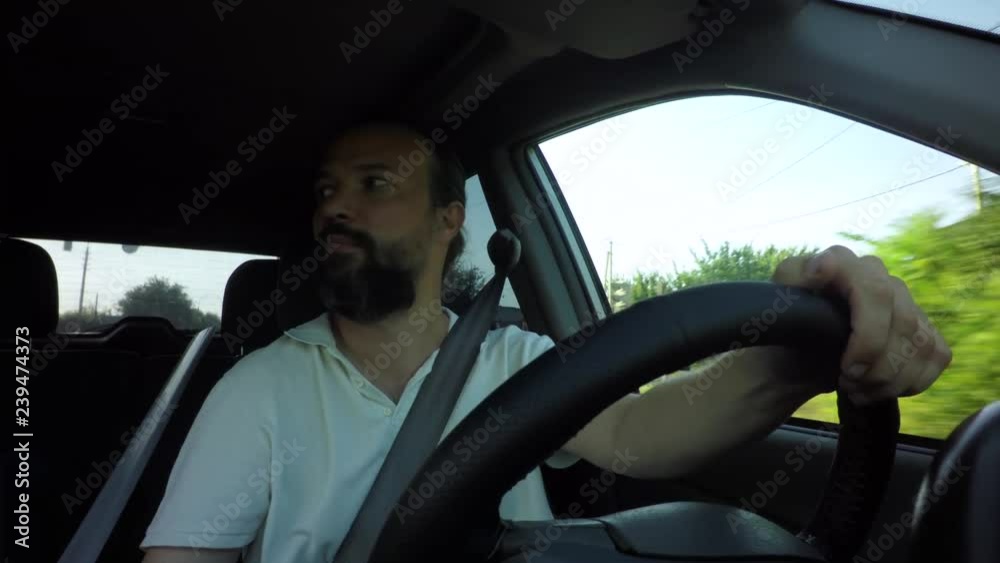 man  driving car traveling