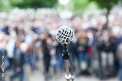Microphone in focus against blurred crowd © wellphoto