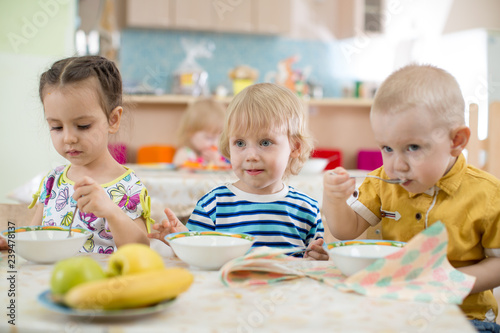 Kids eating in kindergarten or day care centre