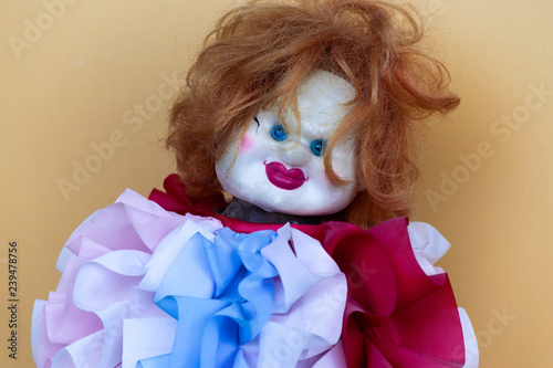 Creepy clown doll in colorful clothes