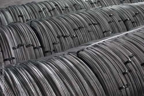 Coils of galvanized metal steel rod wire in a warehouse