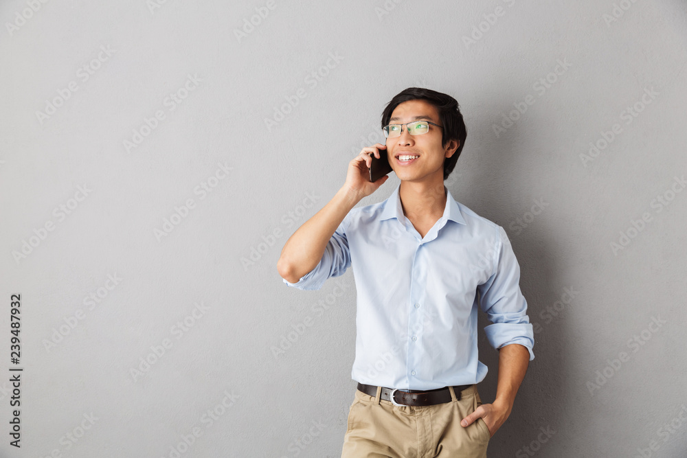 Smiling asian business man standing isolated Smiling asian business man standing isolated