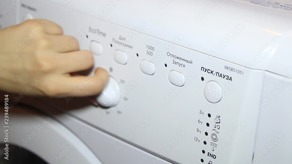 Female hand includes washing machine settings Female hand includes washing machine settings