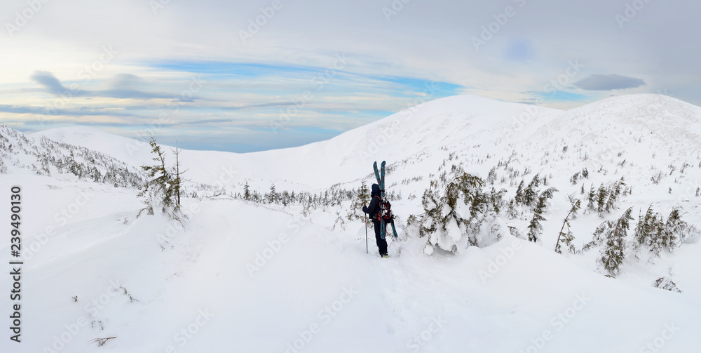 Alpine touring skier in winter mountains.