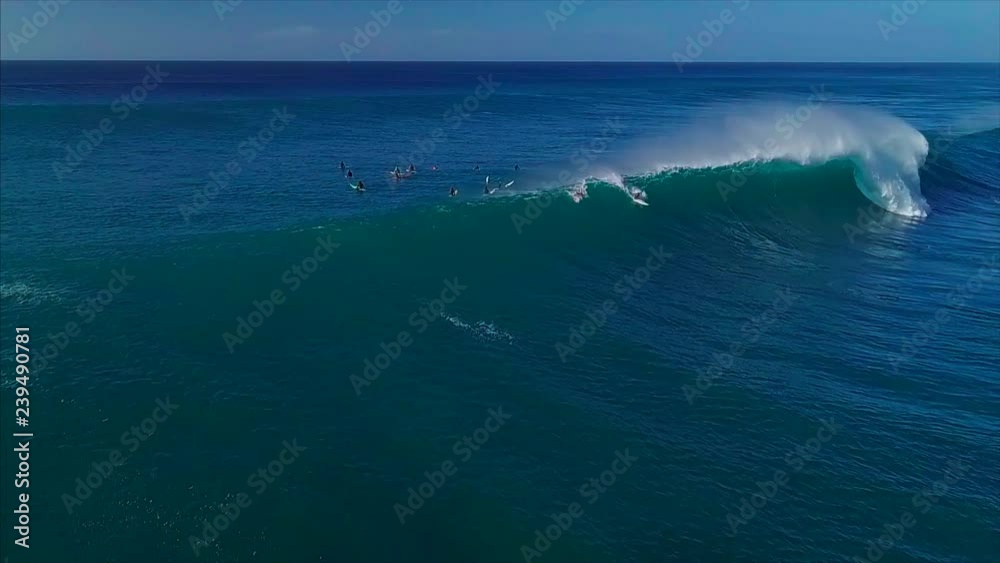 Aerial view of the surfer riding big wave on the North Shore of Oahu, Hawaii Aerial view of the surfer riding big wave on the North Shore of Oahu, Hawaii