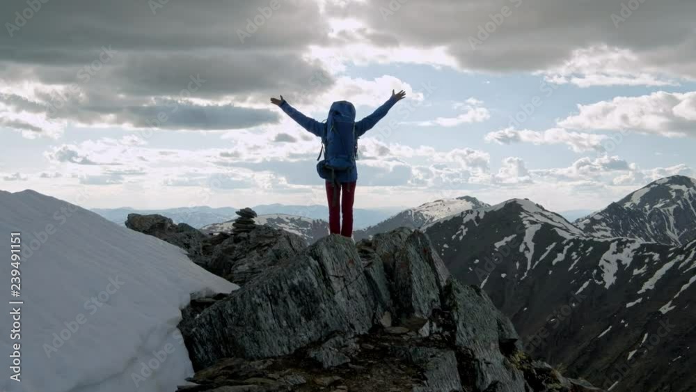successful young woman backpacker open arms on mountain peak successful young woman backpacker open arms on mountain peak